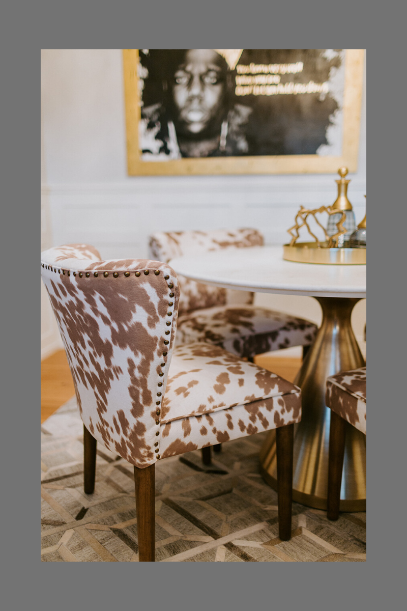 Cowhide print chair featured in the home office of Kelly Ruth.